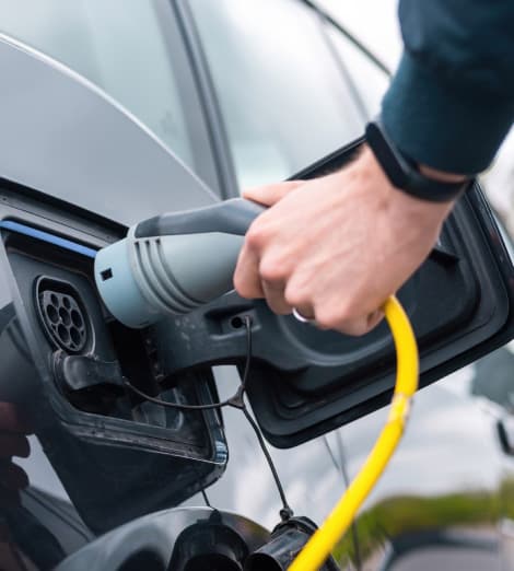 PlugMap app interface displaying nearby EV charging stations